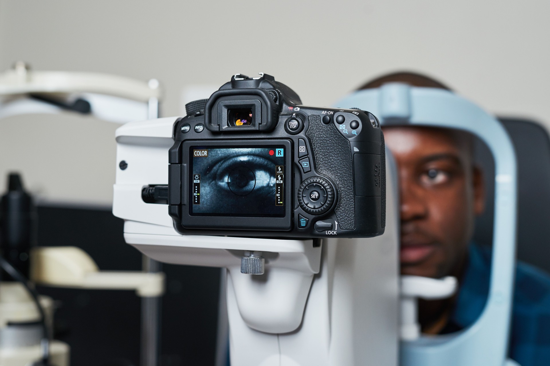 Optometrist Conducting Eye Examination Using Advanced Diagnostic Equipment in Modern Clinic Setting